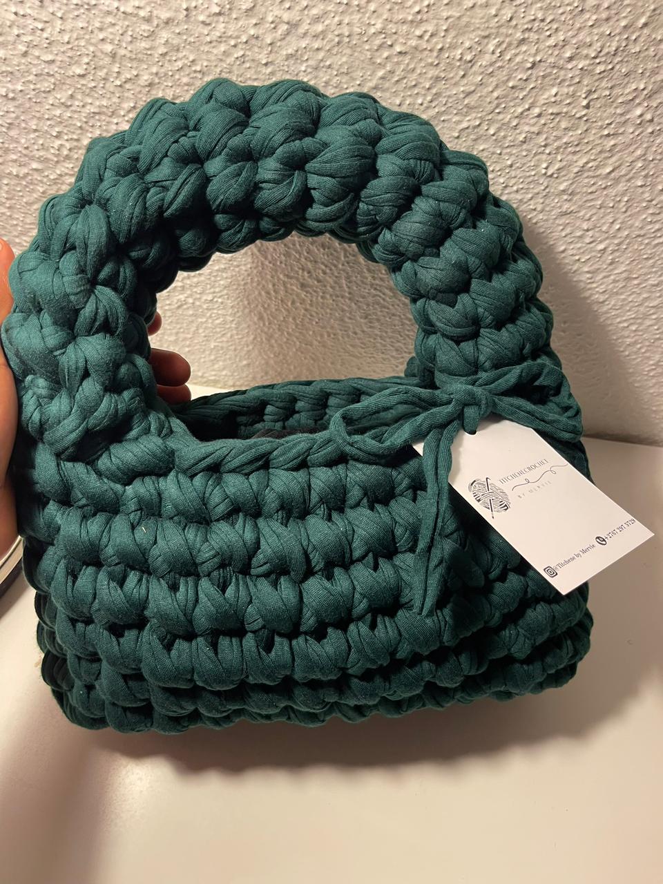 A green handcrafted crochet handbag